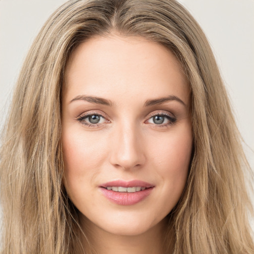 Joyful white young-adult female with long  brown hair and green eyes