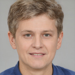Joyful white adult male with short  brown hair and grey eyes