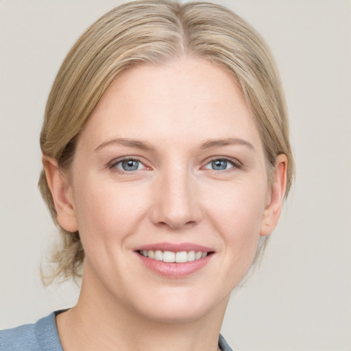 Joyful white young-adult female with medium  brown hair and blue eyes