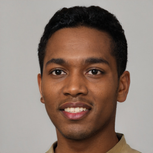 Joyful black young-adult male with short  black hair and brown eyes