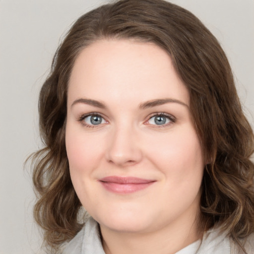 Joyful white young-adult female with medium  brown hair and green eyes