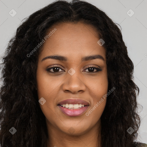 Joyful black young-adult female with long  brown hair and brown eyes