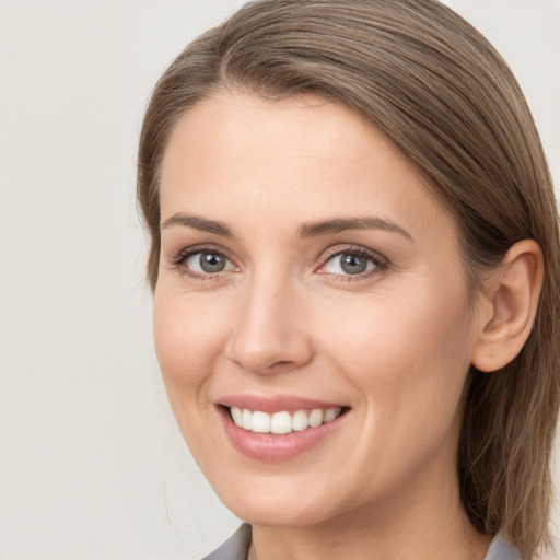 Joyful white young-adult female with long  brown hair and grey eyes