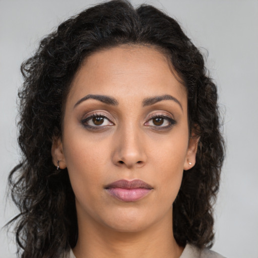 Neutral latino young-adult female with long  brown hair and brown eyes