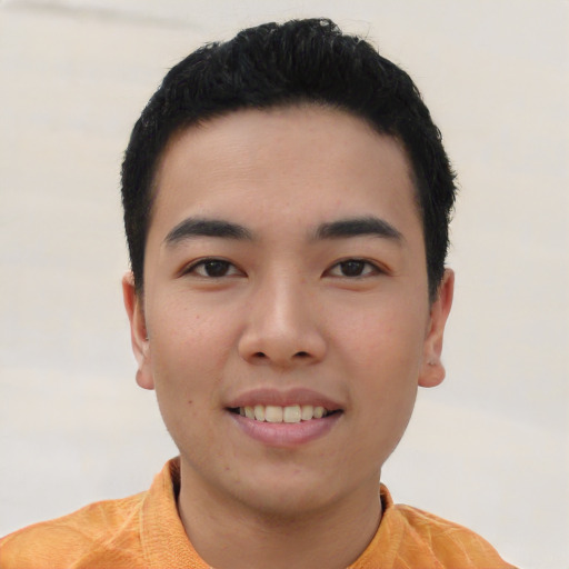 Joyful asian young-adult male with short  black hair and brown eyes