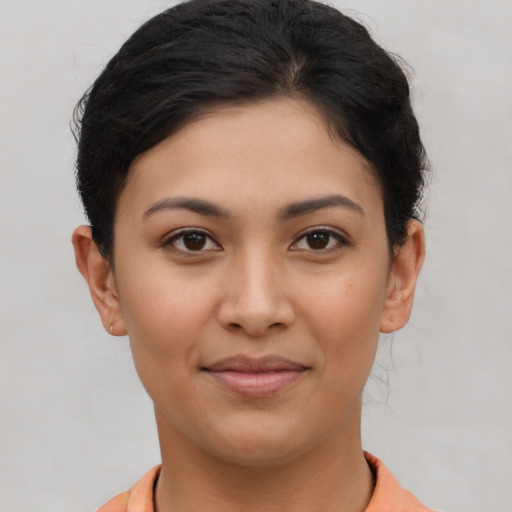Joyful latino young-adult female with short  brown hair and brown eyes