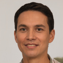 Joyful white young-adult male with short  black hair and brown eyes