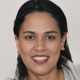 Joyful latino young-adult female with medium  brown hair and brown eyes