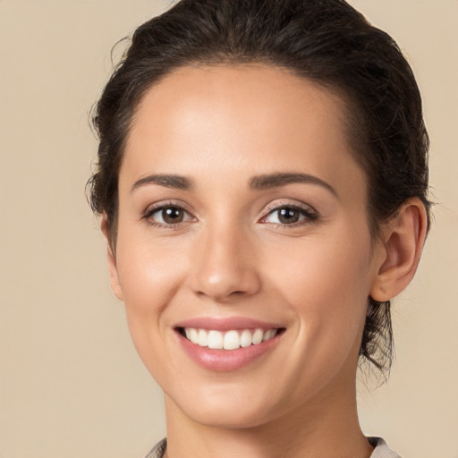 Joyful white young-adult female with medium  brown hair and brown eyes