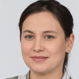 Joyful white adult female with medium  brown hair and brown eyes