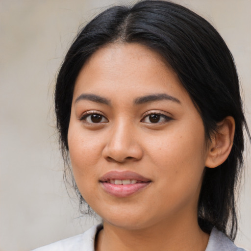 Joyful latino young-adult female with medium  black hair and brown eyes