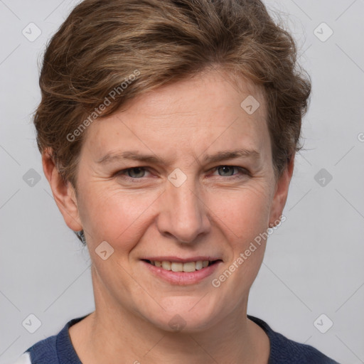 Joyful white adult female with short  brown hair and grey eyes