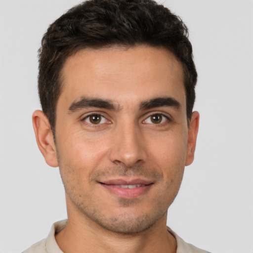 Joyful white young-adult male with short  brown hair and brown eyes