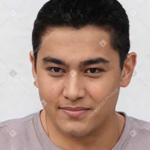 Joyful latino young-adult male with short  brown hair and brown eyes