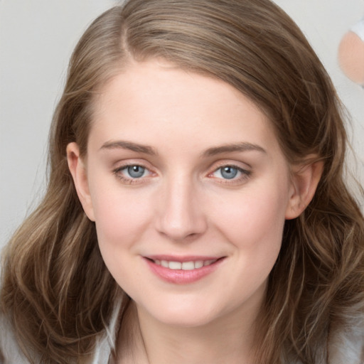 Joyful white young-adult female with long  brown hair and grey eyes