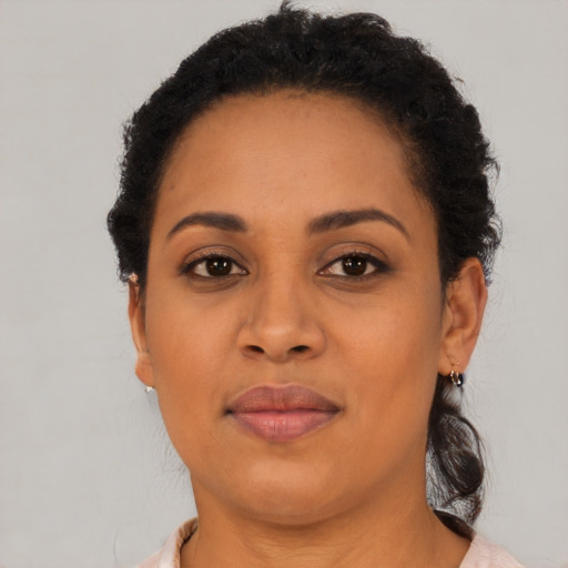 Joyful black adult female with short  brown hair and brown eyes
