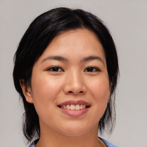 Joyful asian young-adult female with medium  black hair and brown eyes