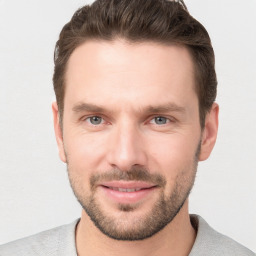 Joyful white young-adult male with short  brown hair and grey eyes