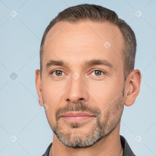 Joyful white adult male with short  brown hair and brown eyes