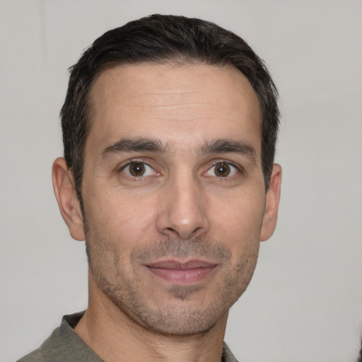 Joyful white adult male with short  brown hair and brown eyes