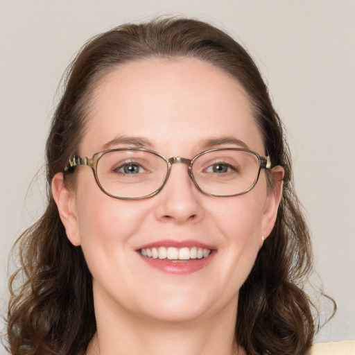 Joyful white adult female with medium  brown hair and blue eyes