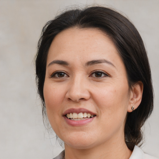 Joyful white adult female with medium  brown hair and brown eyes