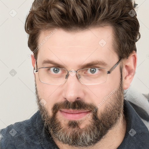 Joyful white adult male with short  brown hair and grey eyes