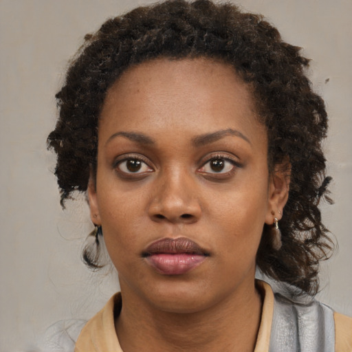 Neutral black young-adult female with medium  brown hair and brown eyes
