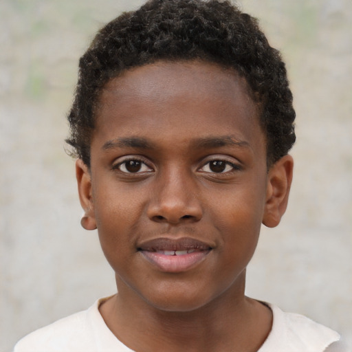Joyful black child male with short  brown hair and brown eyes
