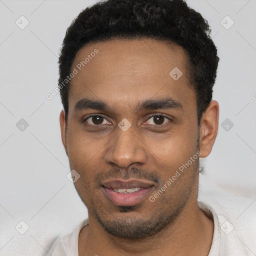 Joyful black young-adult male with short  black hair and brown eyes