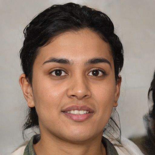 Joyful latino young-adult female with medium  brown hair and brown eyes