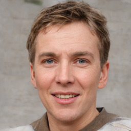 Joyful white adult male with short  brown hair and grey eyes