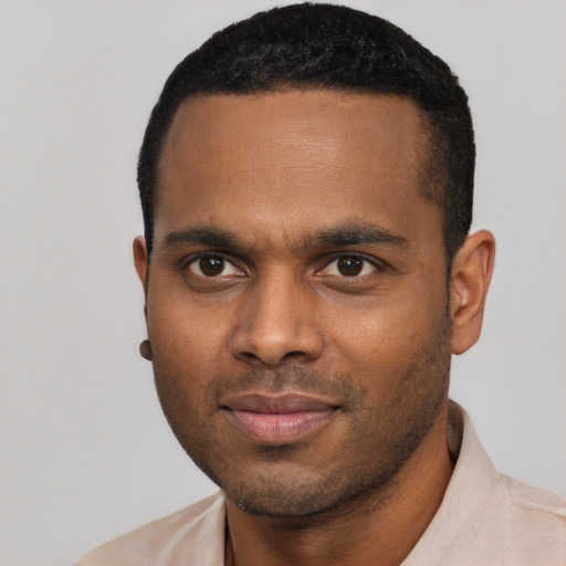 Joyful black young-adult male with short  black hair and brown eyes