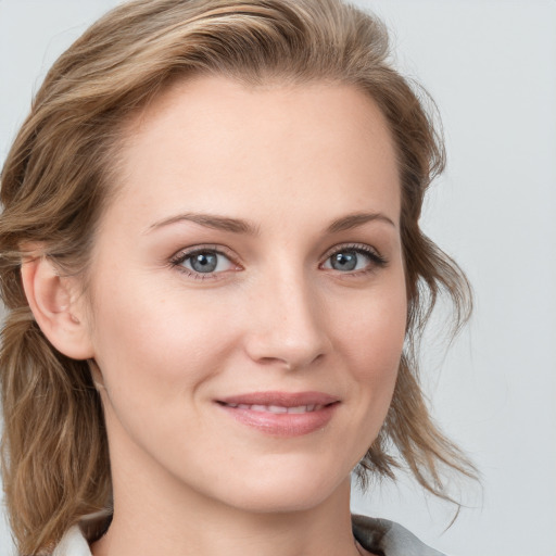 Joyful white young-adult female with medium  brown hair and blue eyes