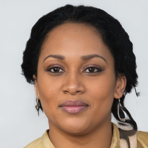 Joyful black young-adult female with short  black hair and brown eyes