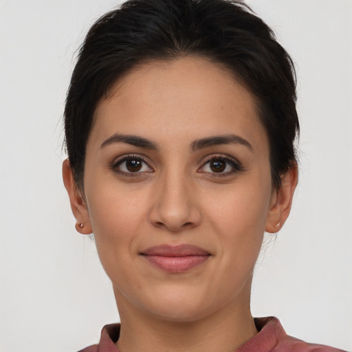 Joyful latino young-adult female with short  brown hair and brown eyes