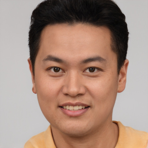 Joyful white young-adult male with short  brown hair and brown eyes