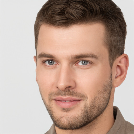 Joyful white young-adult male with short  brown hair and grey eyes