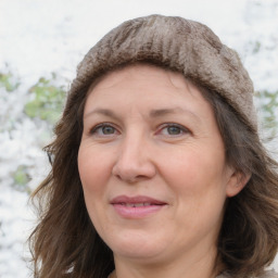 Joyful white adult female with long  brown hair and brown eyes