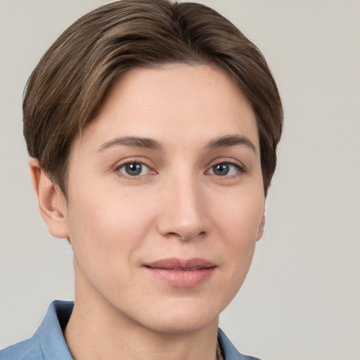 Joyful white young-adult female with short  brown hair and grey eyes