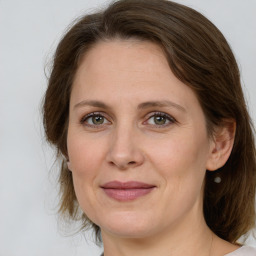 Joyful white adult female with medium  brown hair and grey eyes