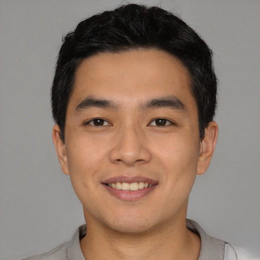 Joyful asian young-adult male with short  black hair and brown eyes