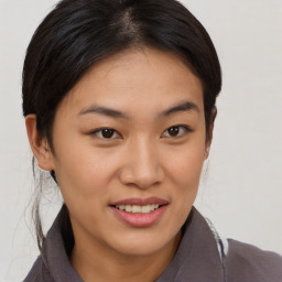 Joyful asian young-adult female with short  brown hair and brown eyes