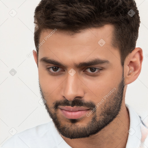 Joyful white young-adult male with short  brown hair and brown eyes