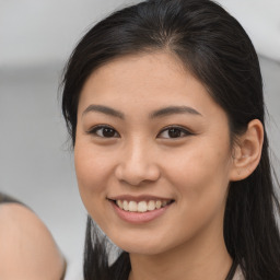 Joyful asian young-adult female with long  brown hair and brown eyes