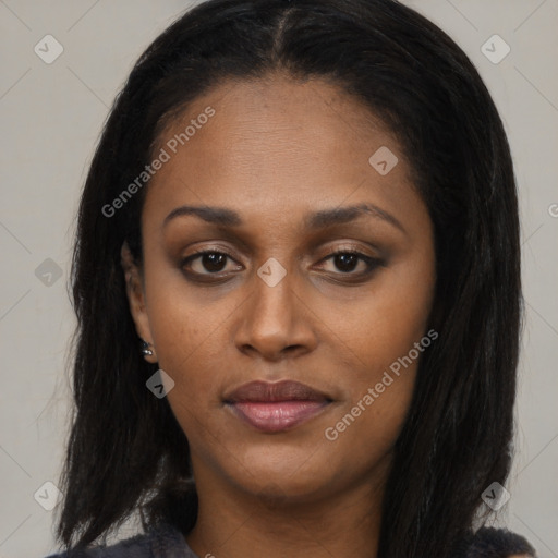 Joyful black young-adult female with long  black hair and brown eyes