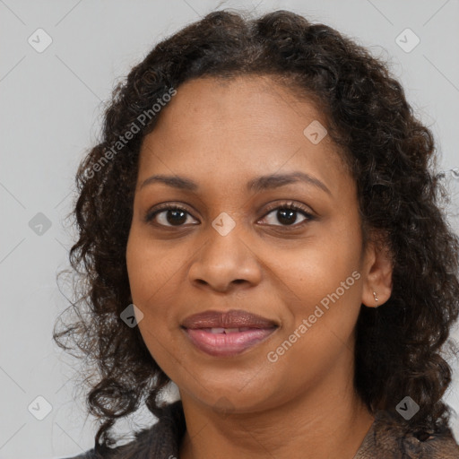 Joyful black adult female with medium  brown hair and brown eyes