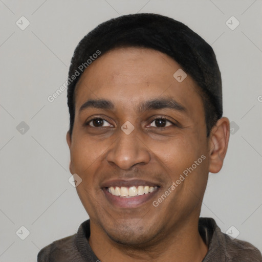 Joyful latino young-adult male with short  black hair and brown eyes