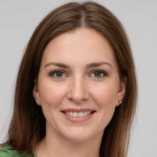 Joyful white young-adult female with long  brown hair and grey eyes