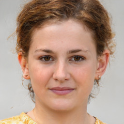 Joyful white child female with medium  brown hair and brown eyes